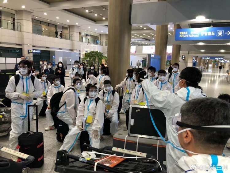 中国女足抵达韩国仁川机场 身穿全套防护服 认真防疫